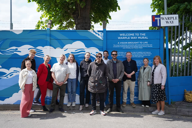 Members of the local community by the Warple Way Mural