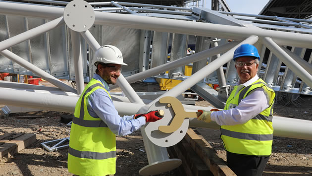 Brentford FC Chairman Cliff Crown is holding the spanner and Giancarlo Torpiano from Arup, our architect, is holding the bolt
