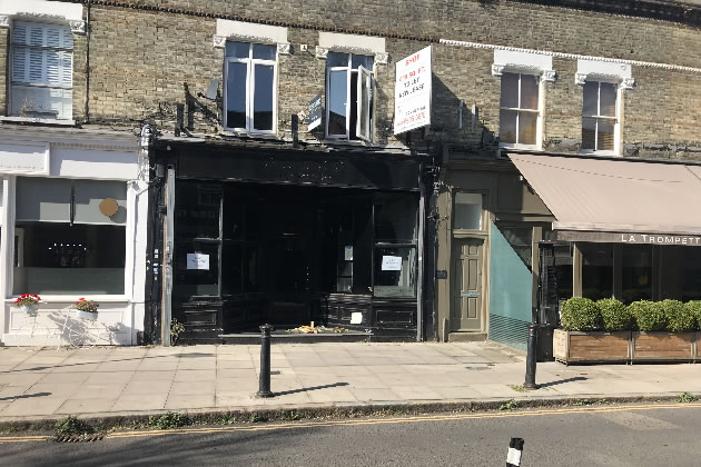 Flowers and a candle let in the doorway