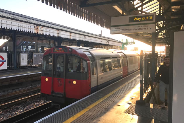 A Piccadilly line train travelling through Turnham Green Station