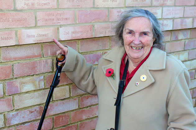 Rena Stewart points to the brick laid in her honour at Bletchley Park 