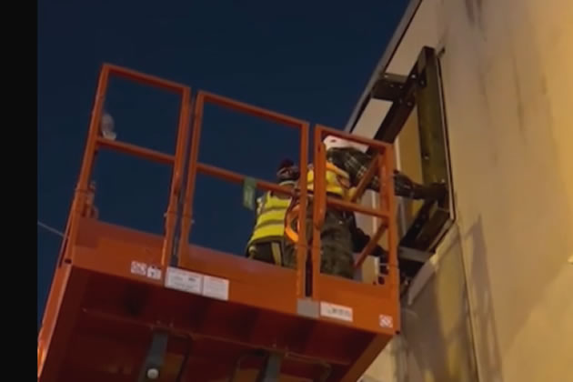 Contractors for Fine Art Restoration remove the section of the wall on which the Banksy was painted.
