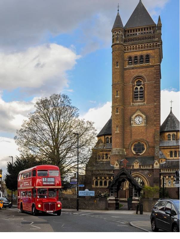 A vintage bus goes past St. Mary's Church in Ealing. Picture: Mark Kehoe