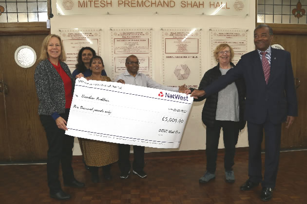 L- r Ruth Cadbury MP, Hitseshree Shah, Shejal Shah and Chunilal Shah, all of Oshwal Shakti, Corinna Smart and Rumit Shah, presenting the cheque